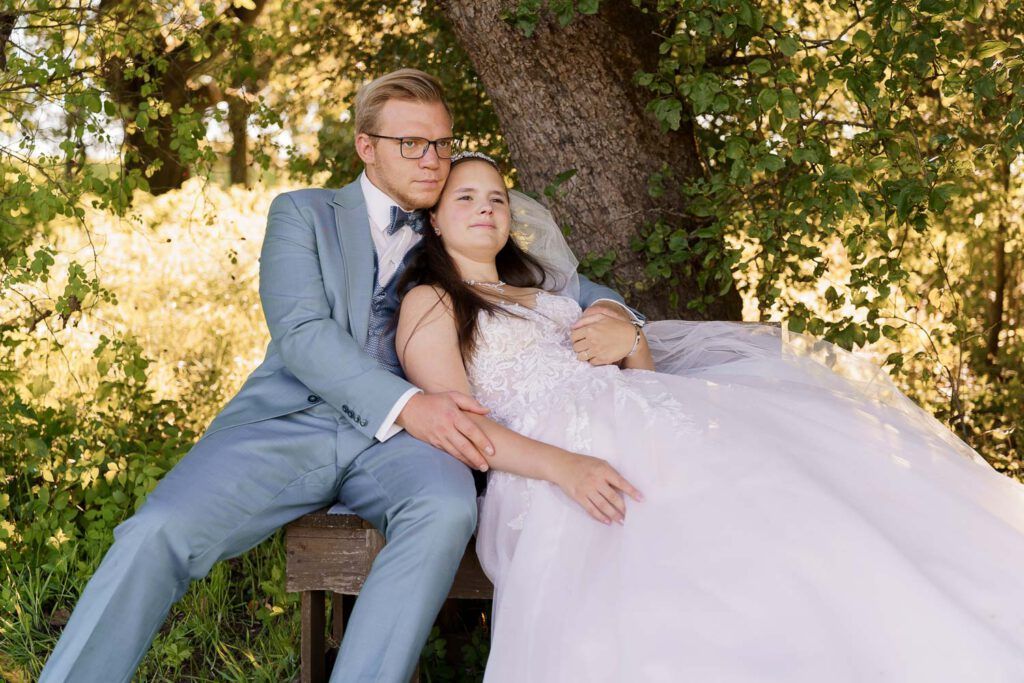 braut lehnt sich an braeutigam auf bank